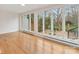 Bright living room features large windows overlooking an outdoor patio with stone flooring and wrought iron furniture at 2027 Meadowood Ln, Charlotte, NC 28211