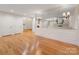 Bright living room featuring hardwood floors, a large mirror and entryway at 2027 Meadowood Ln, Charlotte, NC 28211