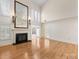 Bright living room with hardwood floors, fireplace, and large windows offering lots of natural light at 2027 Meadowood Ln, Charlotte, NC 28211