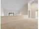 Loft area with neutral carpeting and access to a bathroom and balcony at 2027 Meadowood Ln, Charlotte, NC 28211