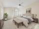 Serene main bedroom with a king bed, soft neutral tones, and a ceiling fan at 2027 Meadowood Ln, Charlotte, NC 28211