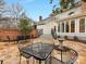 Paver patio with outdoor dining and seating, a decorative fountain, and backyard views at 2027 Meadowood Ln, Charlotte, NC 28211