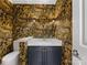 Unique powder room with patterned wallpaper, modern vanity with marble countertop, and stylish sconce lighting at 2027 Meadowood Ln, Charlotte, NC 28211