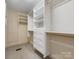 Spacious walk-in closet with custom built-in shelving and drawers for optimal storage solutions at 2027 Meadowood Ln, Charlotte, NC 28211