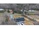 Scenic aerial view of the black barndominium home near a tranquil pond surrounded by lush trees at 2288 Boheler Rd, Clover, SC 29710