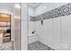 Bright bathroom with patterned tile shower, white subway tile, bench seat, and glass door at 2288 Boheler Rd, Clover, SC 29710