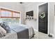 Bedroom featuring a large window with blinds, TV, decorative wall art, and modern decor at 2288 Boheler Rd, Clover, SC 29710