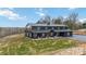Eye-catching barndominium with a covered porch and a pristine lawn, perfect for outdoor relaxation at 2288 Boheler Rd, Clover, SC 29710