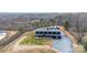 Beautiful barndominium with black siding and a metal roof, complemented by a spacious yard and long driveway at 2288 Boheler Rd, Clover, SC 29710