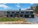 Stunning exterior of a black modern farmhouse with a metal roof, inviting porch, and manicured lawn at 2288 Boheler Rd, Clover, SC 29710