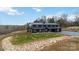 Expansive front view of a modern black barndominium-style house with a well-maintained lawn at 2288 Boheler Rd, Clover, SC 29710