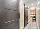 Hallway with visible bedroom, gray rug, and a black sliding door with matching black hardware at 2288 Boheler Rd, Clover, SC 29710