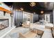 Cozy screened patio with a stone fireplace, comfortable seating, and stylish lighting fixtures at 2288 Boheler Rd, Clover, SC 29710