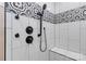 Shower with white tile, black and white decorative tile, matte black fixtures, and bench at 2288 Boheler Rd, Clover, SC 29710