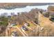 Stunning aerial view of luxury homes with pools near the lake and trees at 247 Reese Wilson Rd, Belmont, NC 28012