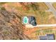 Drone shot displays a home with long driveway and pool in a wooded setting at 247 Reese Wilson Rd, Belmont, NC 28012