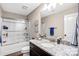 Bathroom featuring a shower-tub combo with sliding glass door and dark wood vanity at 247 Reese Wilson Rd, Belmont, NC 28012