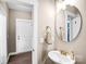 A bright bathroom featuring a sink with gold fixtures and a large round mirror at 247 Reese Wilson Rd, Belmont, NC 28012