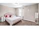 Cozy bedroom with carpet, soft lighting, white nightstands, and large window at 247 Reese Wilson Rd, Belmont, NC 28012