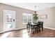 Elegant dining room with a chandelier, a wooden table, and a backyard view near a refreshing pool at 247 Reese Wilson Rd, Belmont, NC 28012