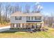 Charming two-story home featuring stone accents, gray siding, a covered porch, and a well-maintained lawn at 247 Reese Wilson Rd, Belmont, NC 28012