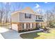 Two-story home boasts stone accents, a two-car garage, well-manicured lawn, and a welcoming front porch at 247 Reese Wilson Rd, Belmont, NC 28012