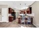 Modern kitchen with dark wood cabinets, stainless steel appliances, an island with barstools, and bright lighting at 247 Reese Wilson Rd, Belmont, NC 28012