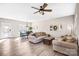 Sunlit living room with a ceiling fan, hardwood floors, two sofas, and an adjacent dining area at 247 Reese Wilson Rd, Belmont, NC 28012