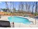 Backyard pool area featuring the pool, a firepit with chairs, and a view of the home at 247 Reese Wilson Rd, Belmont, NC 28012