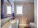 Powder room with granite countertop, window, and updated fixtures at 2729 Duncan Ave, Charlotte, NC 28205