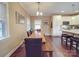 Bright dining room with hardwood floors, a large wooden table, and seamless flow into the kitchen at 2729 Duncan Ave, Charlotte, NC 28205