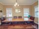 Cozy dining room featuring a large wooden table, bench seating, and ample natural light at 2729 Duncan Ave, Charlotte, NC 28205