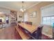 Bright dining room featuring a wooden table, bench seating, and stairway to second floor at 2729 Duncan Ave, Charlotte, NC 28205