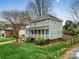 Inviting two-story home featuring a spacious front porch and lush green lawn at 2729 Duncan Ave, Charlotte, NC 28205