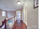 Hallway featuring wood floors, neutral paint, and a ceiling fan at 2729 Duncan Ave, Charlotte, NC 28205