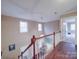 Upstairs hallway featuring wood floors, neutral paint, and natural light at 2729 Duncan Ave, Charlotte, NC 28205