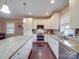 Modern kitchen with stainless steel appliances, granite counters, island, and bright lighting at 2729 Duncan Ave, Charlotte, NC 28205