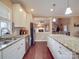 Bright kitchen features white cabinets, stainless steel appliances, granite counters, and an island at 2729 Duncan Ave, Charlotte, NC 28205