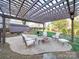 Stone patio with pergola, fire pit and lounge seating at 2729 Duncan Ave, Charlotte, NC 28205