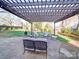 Stone patio with pergola, fire pit and lounge seating at 2729 Duncan Ave, Charlotte, NC 28205