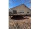 View of the home's backyard featuring a wooden deck, lawn and mature trees at 3002 Willamette Valley Dr, Charlotte, NC 28215