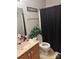 Simple bathroom with a vanity, toilet, and shower with a black curtain at 3002 Willamette Valley Dr, Charlotte, NC 28215
