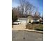 Charming single-story home featuring a driveway, garage, solar panels, and manicured landscaping at 3002 Willamette Valley Dr, Charlotte, NC 28215