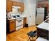 Functional kitchen with wood cabinets, stainless steel refrigerator and laminate countertops at 3002 Willamette Valley Dr, Charlotte, NC 28215