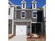 Charming two-story townhome featuring a brick facade, attached garage, and dormer windows at 3509 Nimbell Rd, Monroe, NC 28110