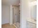 Bathroom showcasing glass shower with tile surround and bright single sink vanity at 3562 Nimbell Rd, Monroe, NC 28110