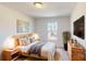 Comfortable bedroom featuring wooden bed frame, modern bedside tables and stylish decor at 3562 Nimbell Rd, Monroe, NC 28110