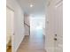 Bright hallway featuring wood floors, staircase with white railing, and recessed lighting at 3562 Nimbell Rd, Monroe, NC 28110