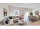 Bright living room area featuring a large sectional sofa and dining table with seating for four at 3562 Nimbell Rd, Monroe, NC 28110
