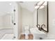 Bathroom featuring a pedestal sink, modern fixtures, and an adjacent room for convenience at 40934 Deer Haven Dr, Albemarle, NC 28001